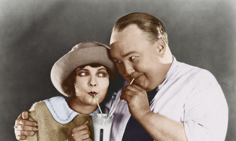 Couple sharing beverage with straw