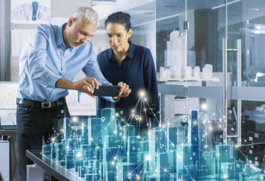 Male and Female Architects Work with Holographic Augmented Reality 3D City Model. Technologically Advanced Office Professional People Use Virtual Reality Modeling Software Application.
