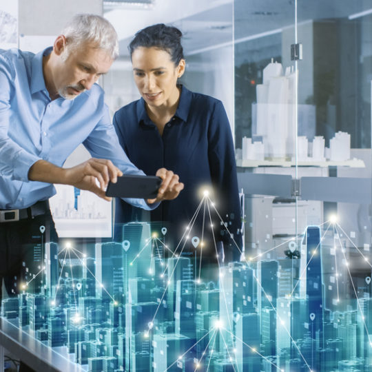 Male and Female Architects Work with Holographic Augmented Reality 3D City Model. Technologically Advanced Office Professional People Use Virtual Reality Modeling Software Application.