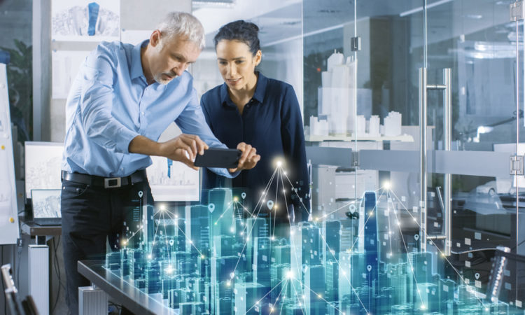 Male and Female Architects Work with Holographic Augmented Reality 3D City Model. Technologically Advanced Office Professional People Use Virtual Reality Modeling Software Application.