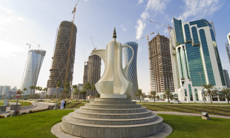 The Dallah coffee pot sculpture on the Corniche in Doha the capital of Qatar, behind it are the new high rise building being built to fill the skyline.