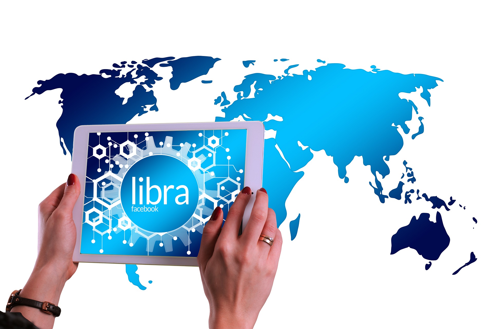 Hands holding a tablet with Libra on the screen with world map in background